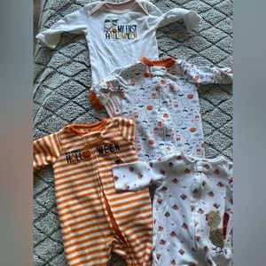 3 sleepers and a onesie all Halloween or fall themed